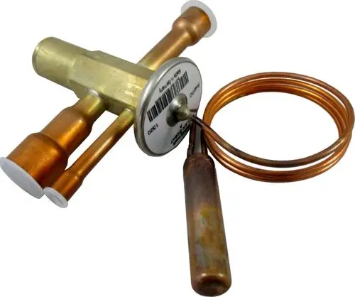 Thermometer für ein Expansionsventil von Wolf, mit Kupferrohren und einer Messspule, befestigt an einer runden Metallplatte.